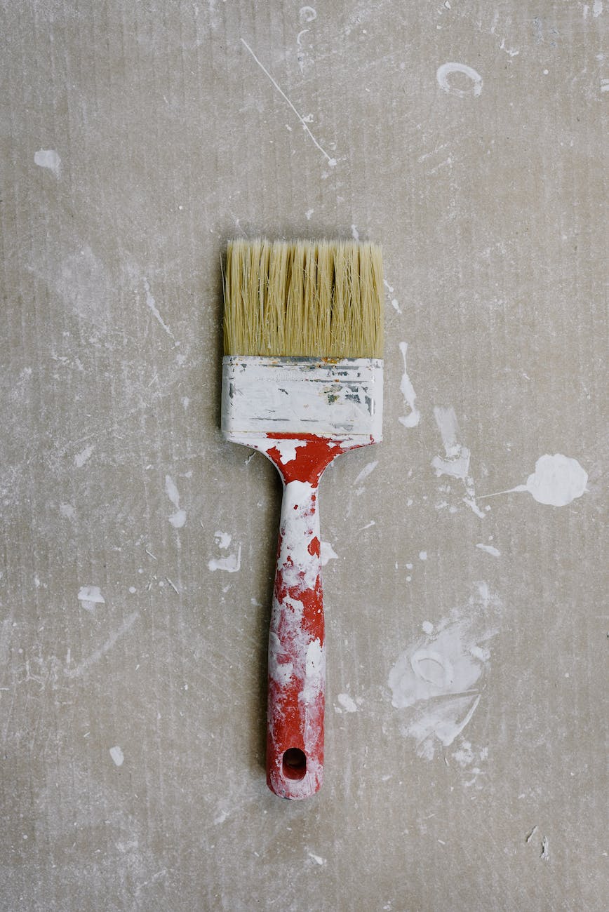 messy paintbrush on dirty floor